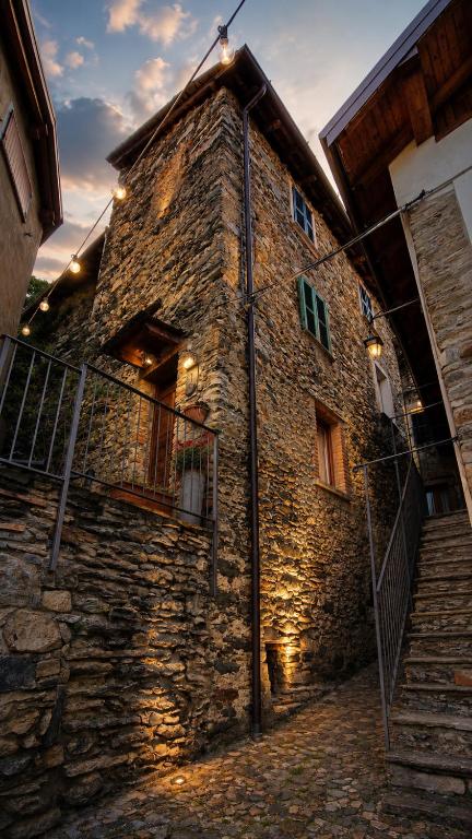 a stone building with stairs in front of it at Rustico Verginate in Bellano