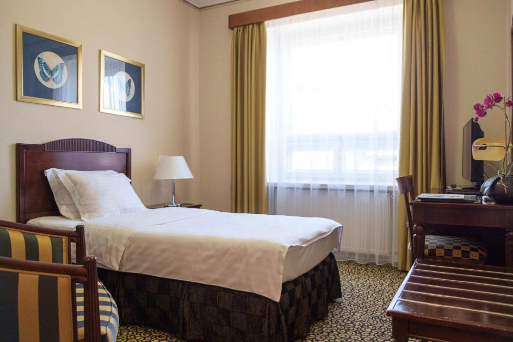 Postel nebo postele na pokoji v ubytování Grand Hotel Viljandi