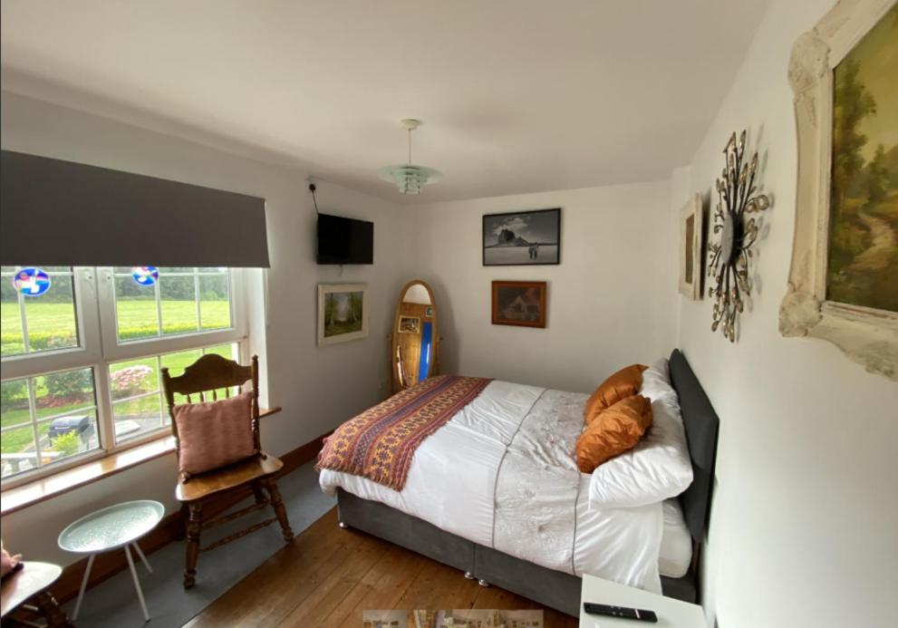 a bedroom with a bed and a desk and a chair at Room Stay 4 in Corran Cross Roads