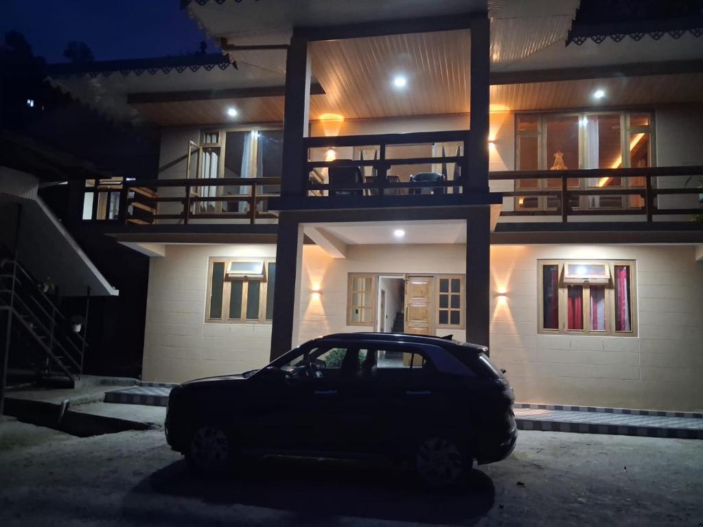 a car parked in front of a house at night at Demazong Homestay in Ravangla