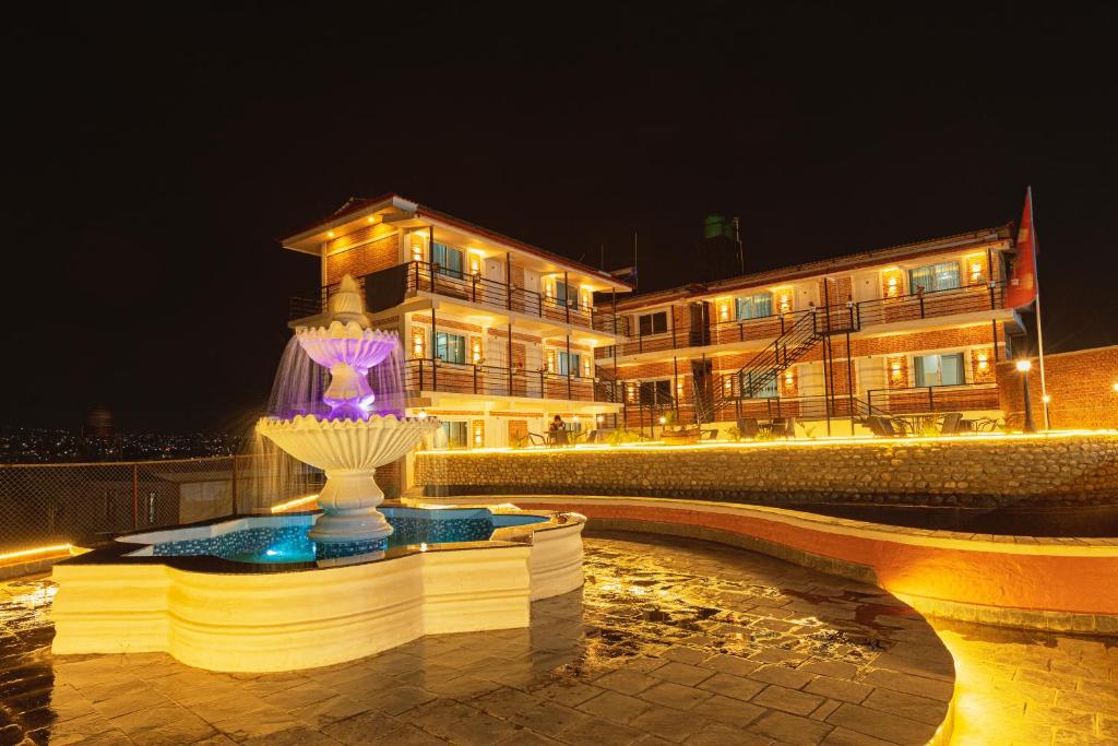 a building with a statue in front of it at night at Shikali Resort in Pātan