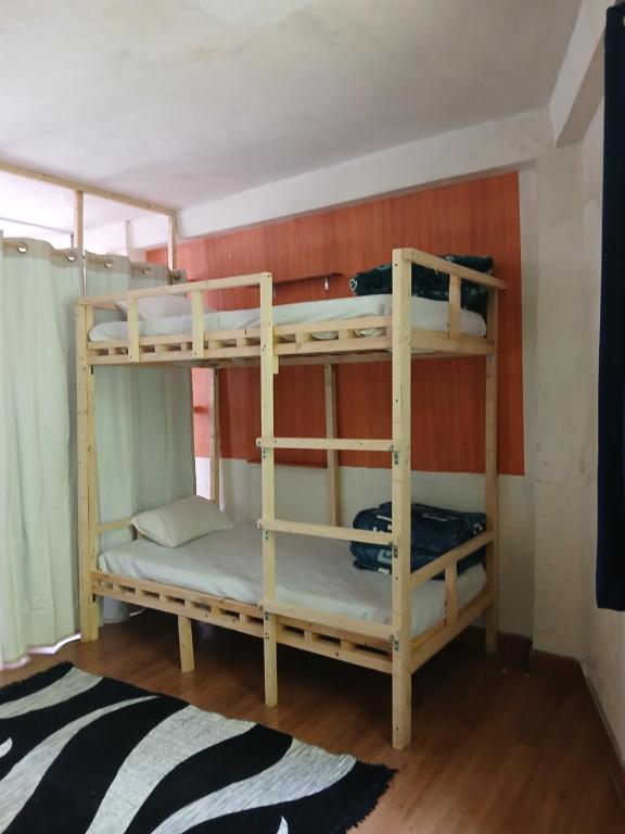 a couple of bunk beds in a room at Dormitory Hatago in Vashisht