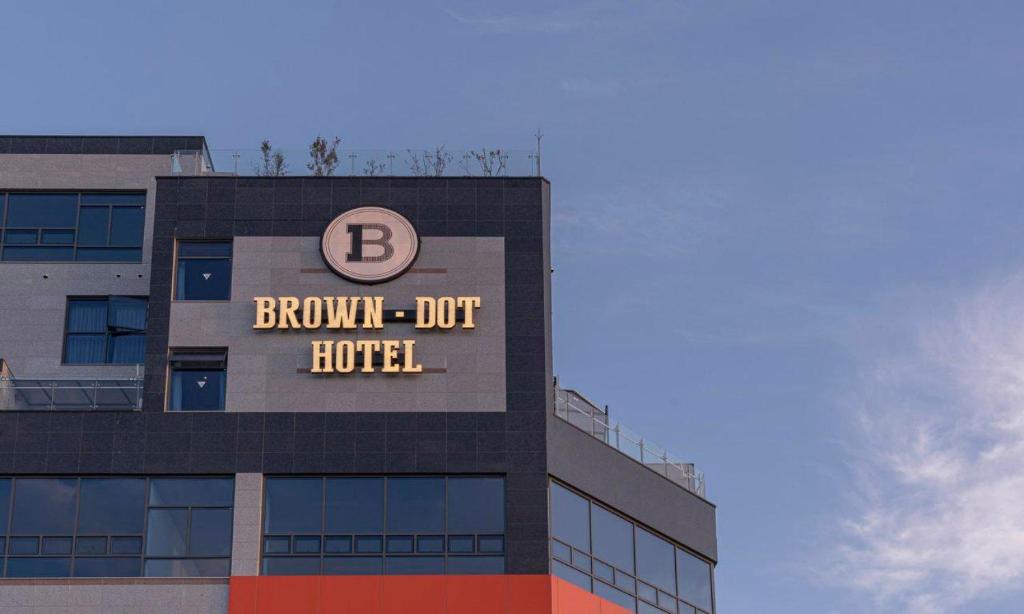 a building with a b burn out hotel sign on it at Brown Dot Hotel Siheung Geobukseom in Siheung