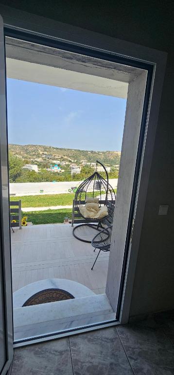 a sliding glass door with a view of a patio at Alora House 2 in Kefalos