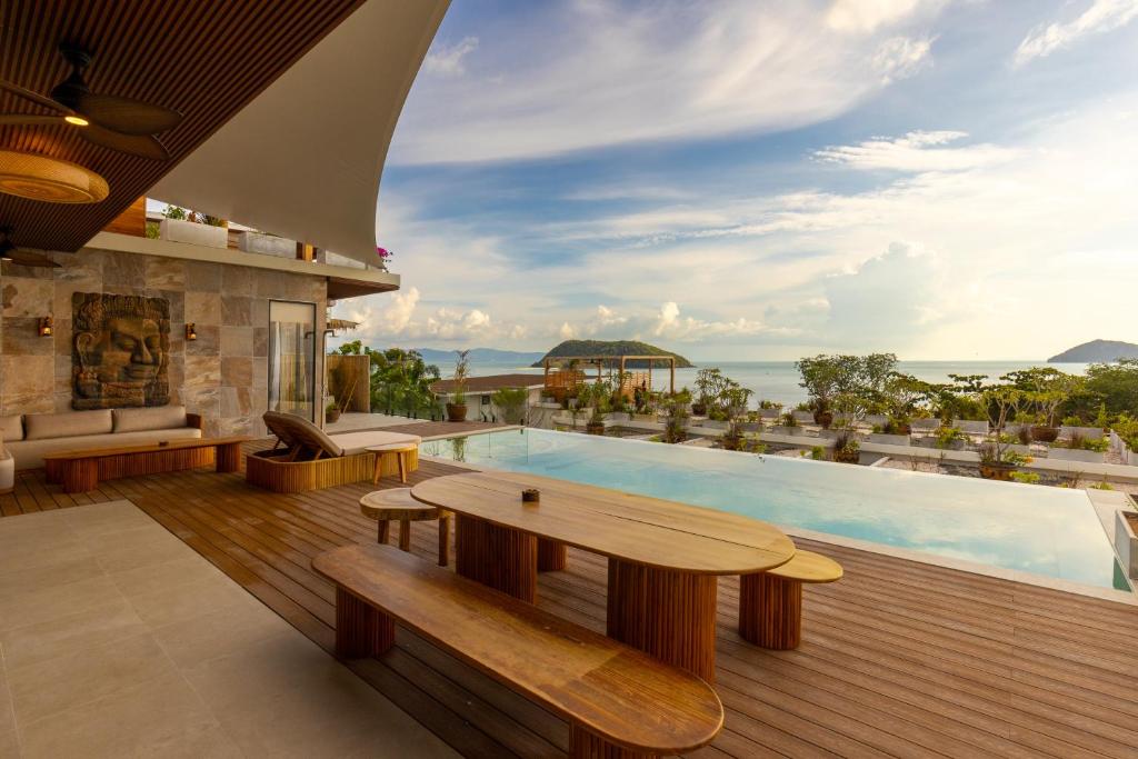 a villa with a swimming pool and a table at Villa Bodhi in Ko Phangan
