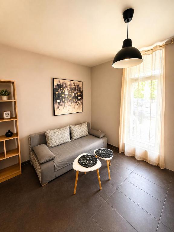 a living room with a couch and a table at Maxi 2 parking included in Sofia