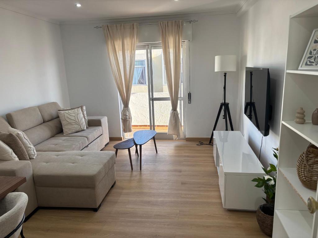 a living room with a couch and a table at Casa Borges in Quelfes