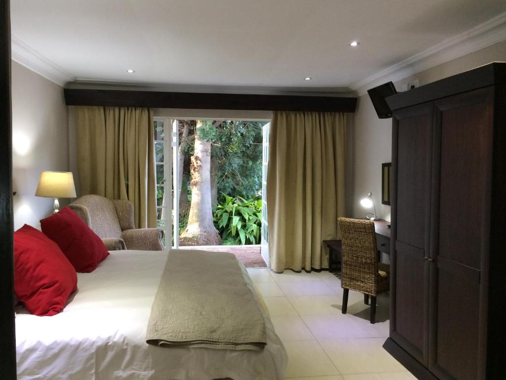 a bedroom with a bed and a sliding glass door at Polokwane Place in Polokwane