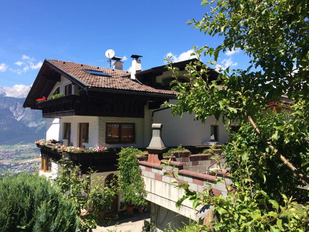 a house on the side of a hill at Pension Erlerhof Chez Karin in Tulfes