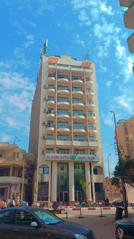 a tall building with a car parked in front of it at فندق الصفا السياحي سوهاج in Sūhāj