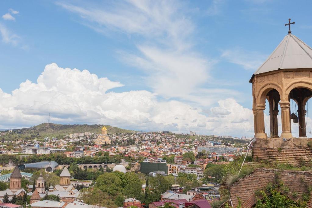 a church tower with a view of a city at Bethlehem Terrace in Tbilisi City