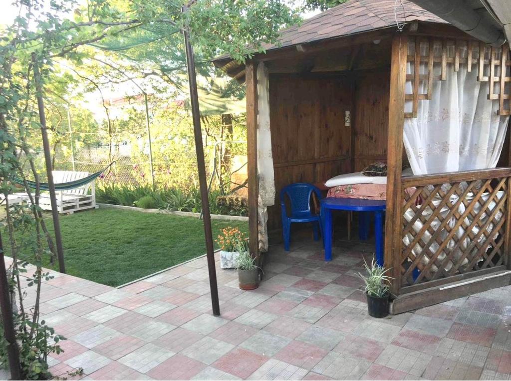 a gazebo with a table and a chair in a yard at Лана бугаз in Karolino-Buhaz