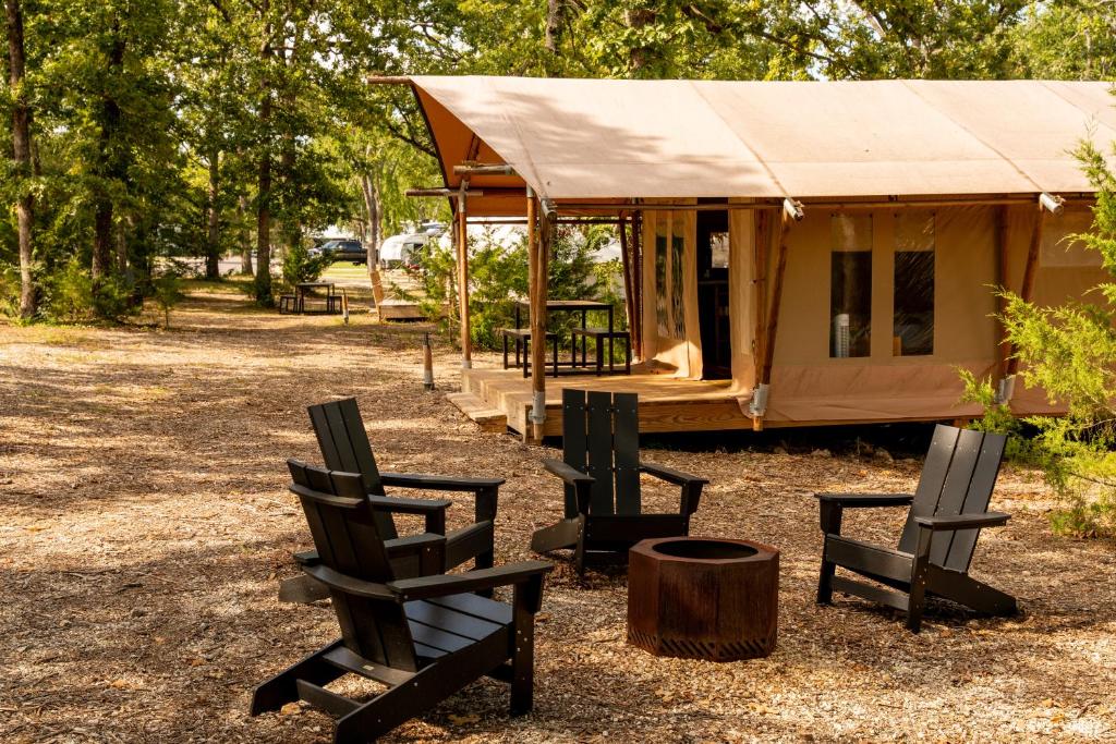 a couple of chairs sitting in front of a yurt at Glamping Tent, Hike, Smore Vibes in Branson