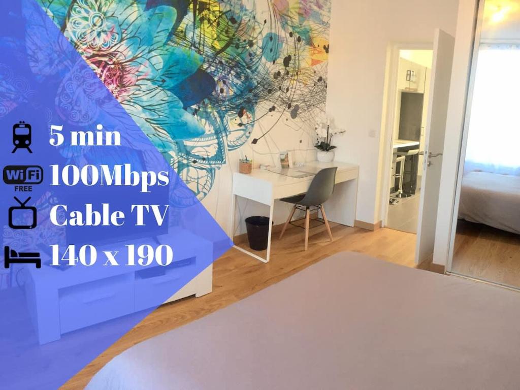 a bedroom with a bed and a desk and a wall at The Pearl in Vitry-sur-Seine
