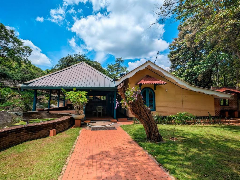 a house with a brick walkway in front of it at Galpothuyaya Eco Lodge Kandalama in Dambulla