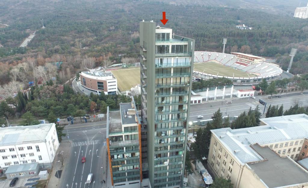 a tall building with a red arrow on top of it at Full Comfort Apartment at Chavchavadze in Tbilisi City
