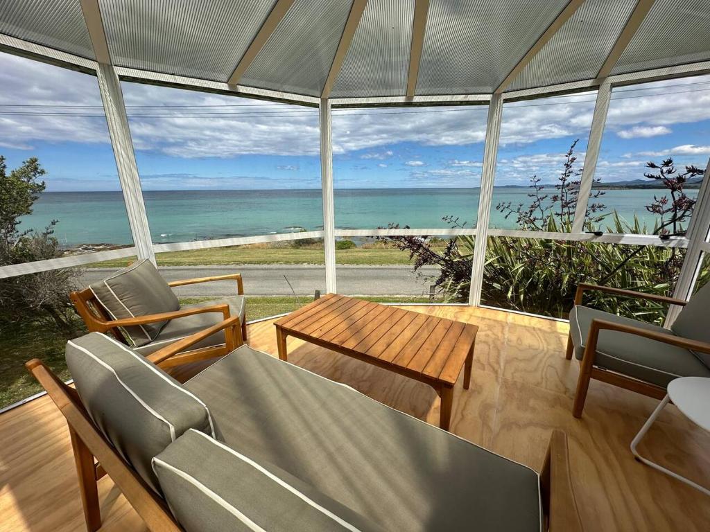 a living room with a view of the ocean at Kakanui Ocean Views in Kakanui