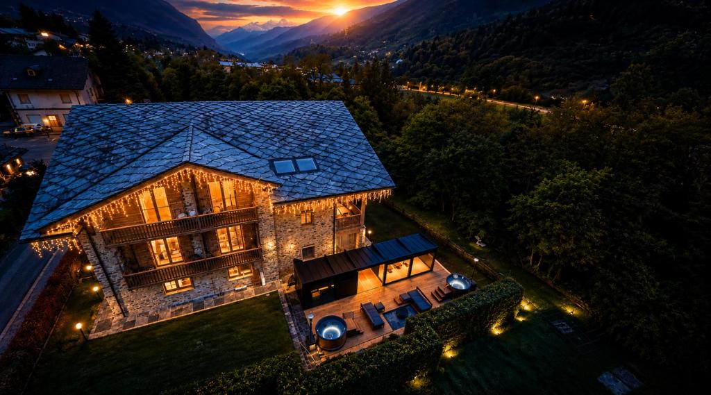 an aerial view of a house with lights at Hotel Les Montagnards in Morgex
