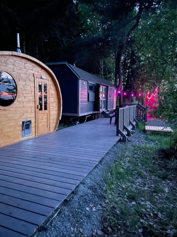a large wooden deck with a tiny house at Maringotka u lesa in Staňkovice