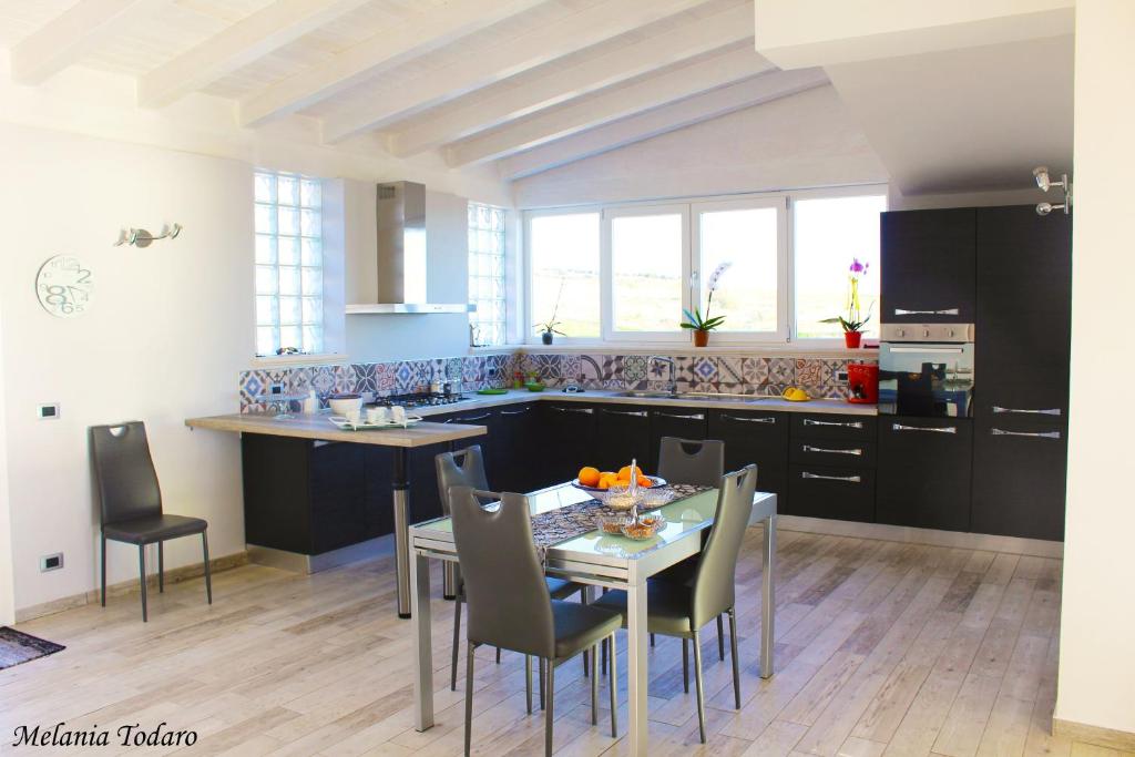 a kitchen with a table and chairs in a room at Villa Cecilia in Montallegro