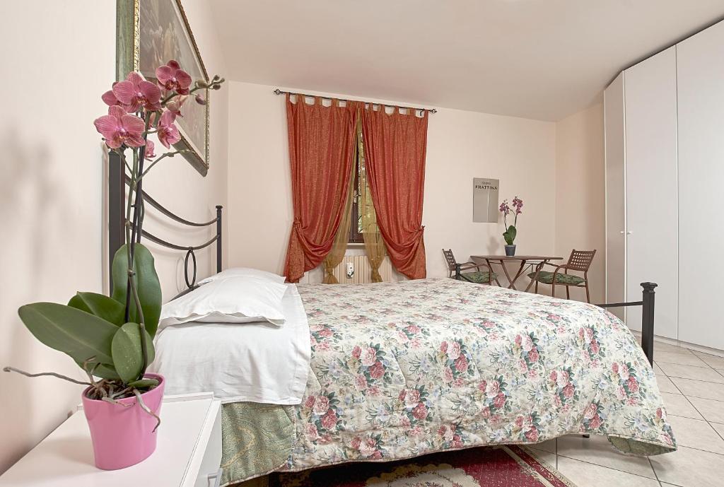 una camera da letto con un letto con copriletto floreale di Il Melograno a Foligno