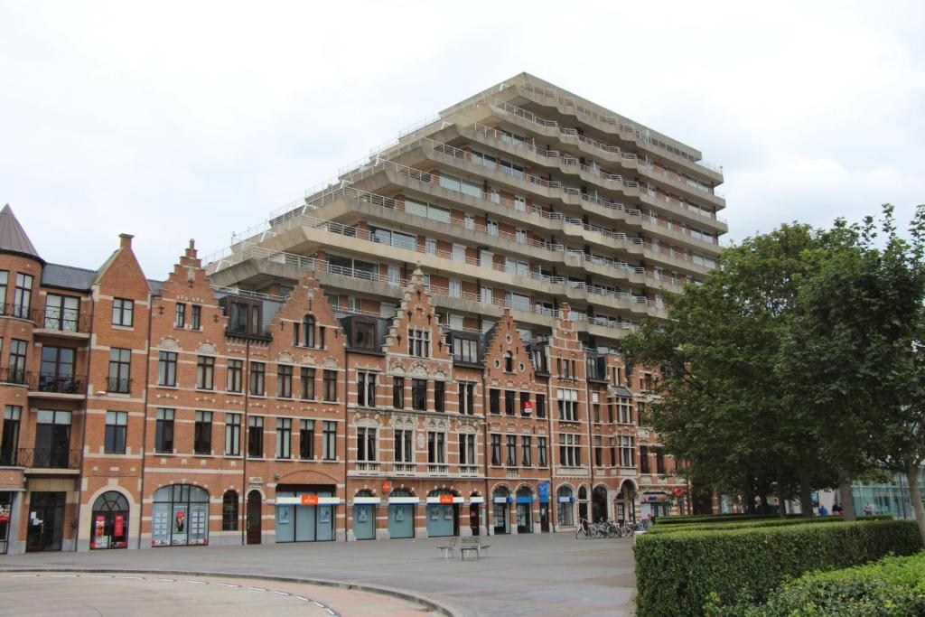 a large building in front of a large building at Marina Mercator in Ostend