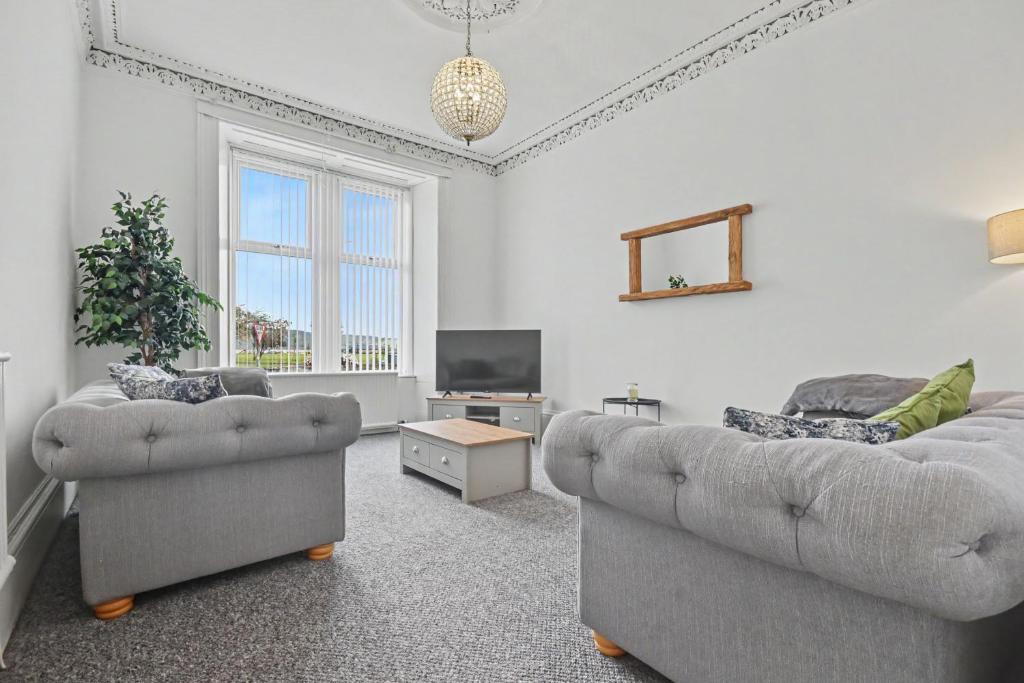 a living room with two couches and a tv at 173 Newark Street, Greenock in Greenock