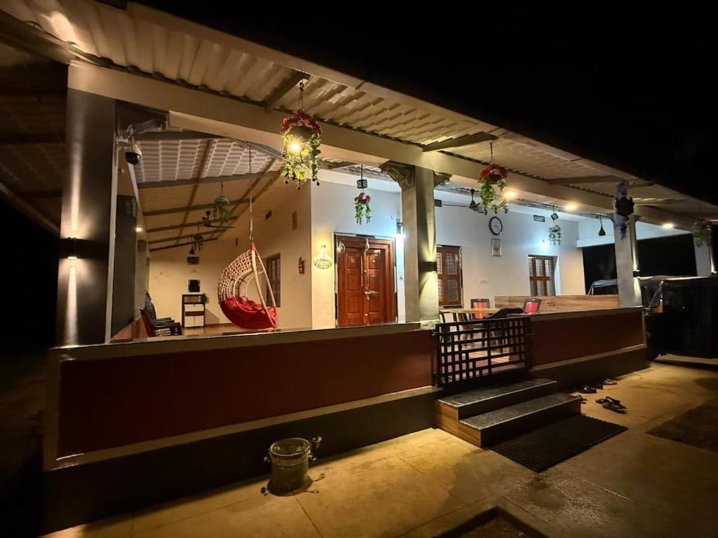 an empty room with stairs in a building with lights at Deepa HomeStay in Dharmastala