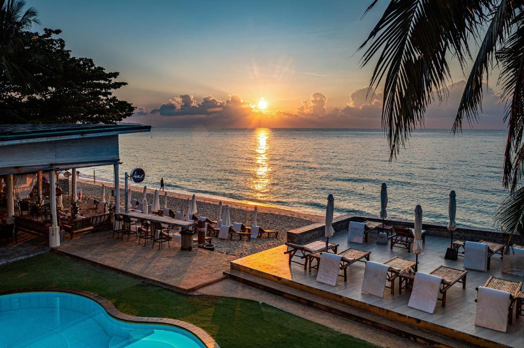 a view of the ocean with a sunset in the background at 4U Resort Samui in Lamai