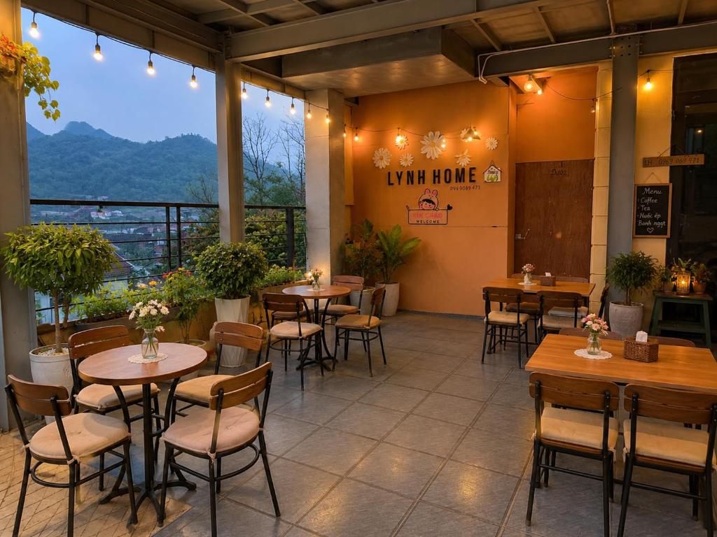 a restaurant with tables and chairs and a view at LYNH HOUSE - Đồng Văn in Dồng Văn