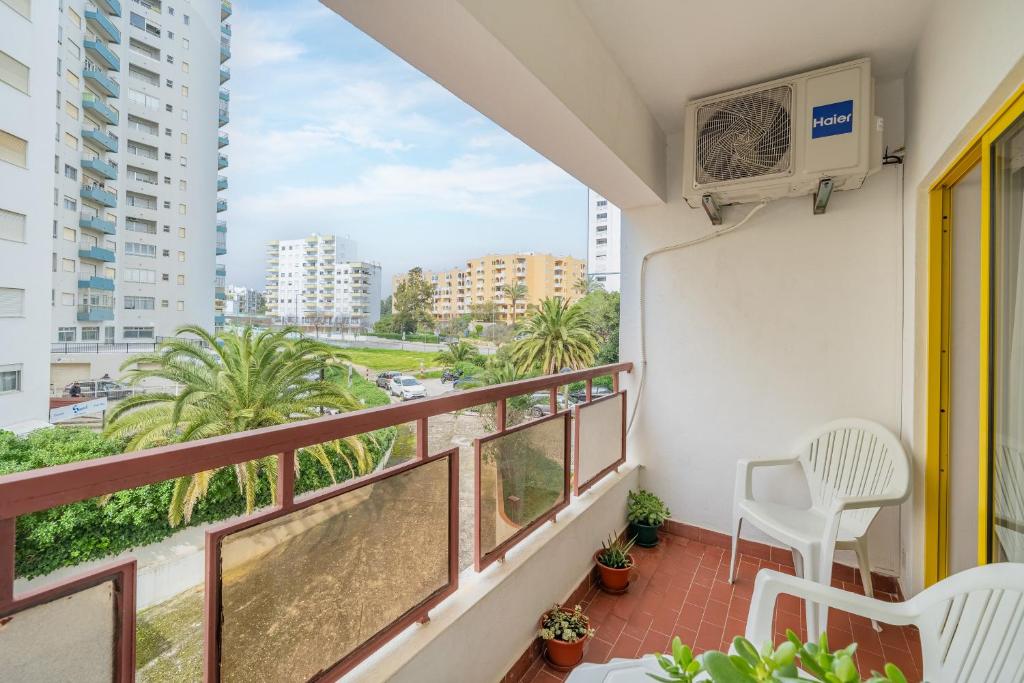 a balcony with a view of a city at Sweet home rp – t1 em portimão in Portimão