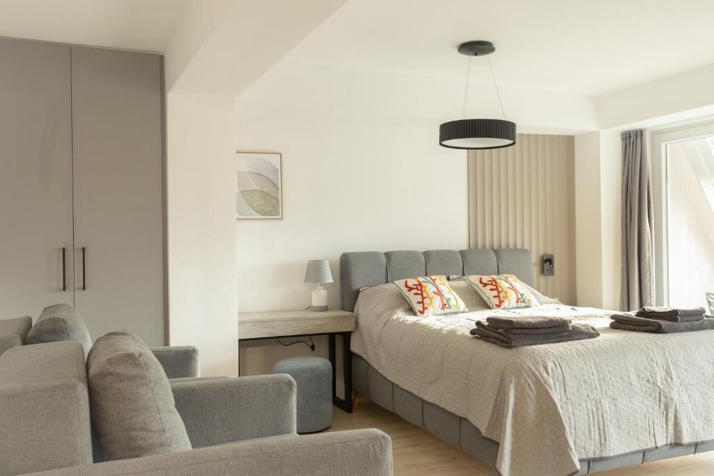 a bedroom with a bed and a couch at The Spot Apartments in Ohrid