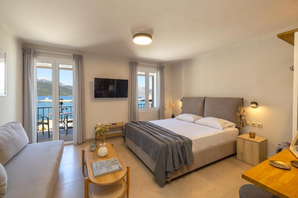 a bedroom with a bed and a living room at Cavaliere Seafront House - Klio in Sami