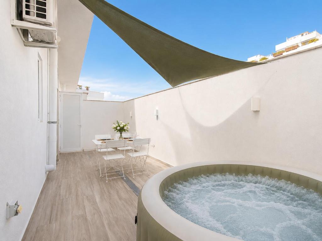 a bathroom with a tub in the middle of a building at 3-Bedroom with Jacuzzi & Private Terrace in Is-Swieqi