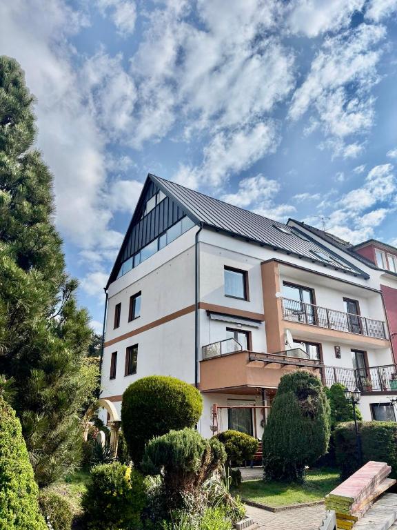 a large white building with a black roof at Vila Adéla - Teplice in Teplice