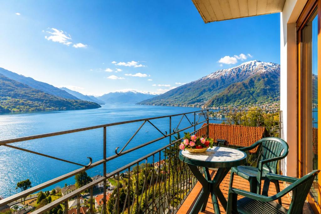 a balcony with a table and chairs and a view of a lake at Apartment Alex 1 in Domaso in Domaso