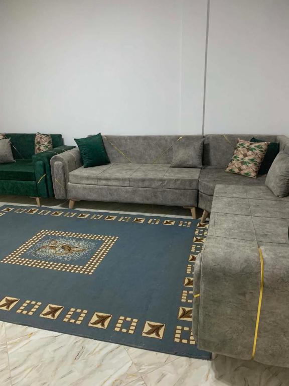 a living room with a couch and a rug at Hostel MJ ,Sidi kbir in Zarzis