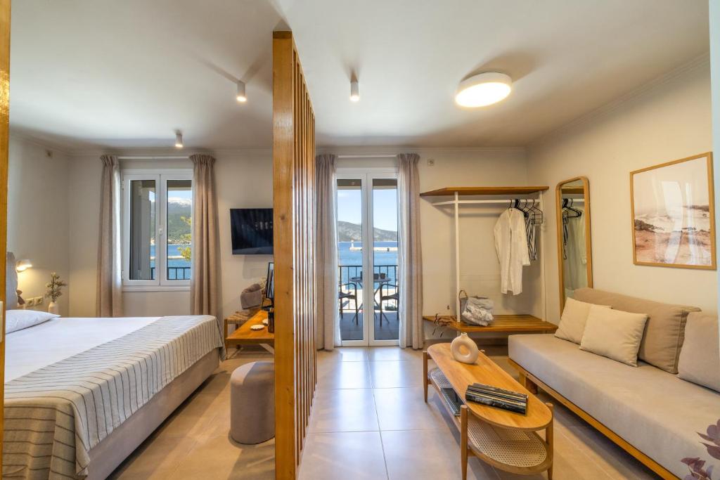 a hotel room with a bed and a couch at Cavaliere Seafront House - Theseus in Sami