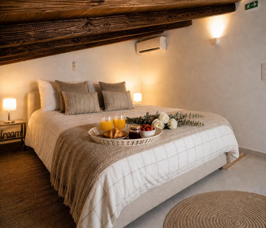 a bedroom with a bed with a tray of food on it at Romantic loft in Tríkala
