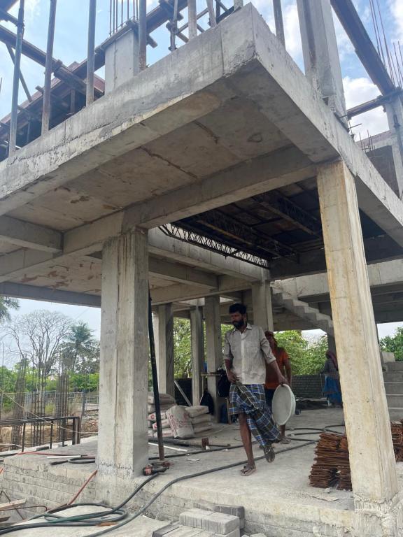 a man is standing under a bridge at grand oceana resort in Covelong