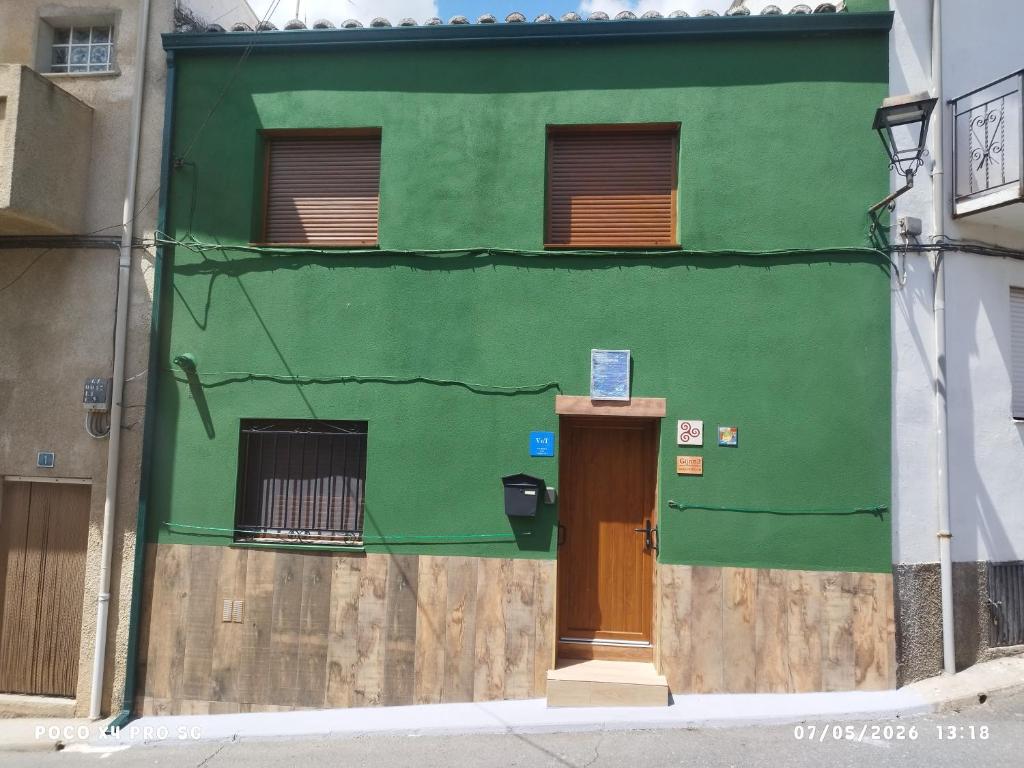 a green building with a door in the side of it at CASA GORDON in Navaluenga