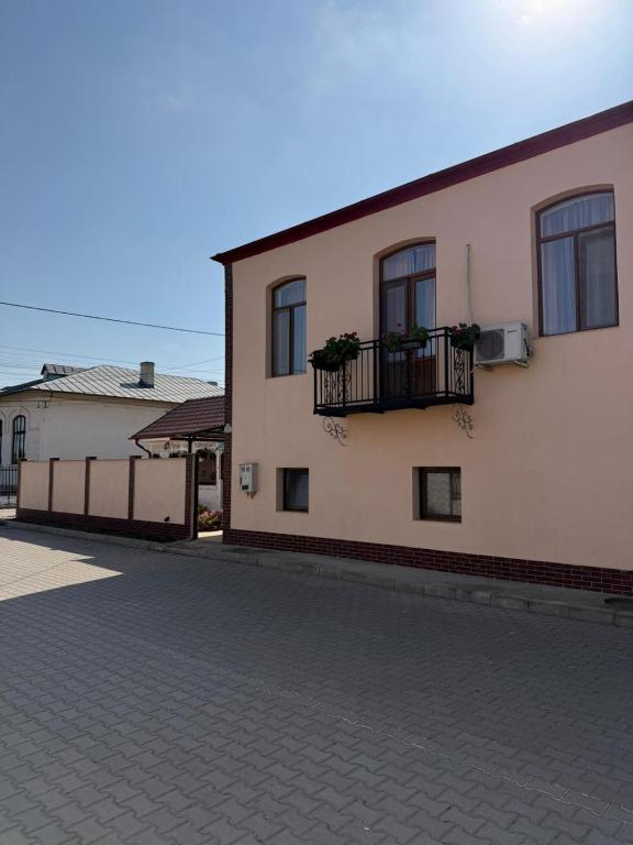 a building with a balcony on the side of it at Casa Alexander in Sulina