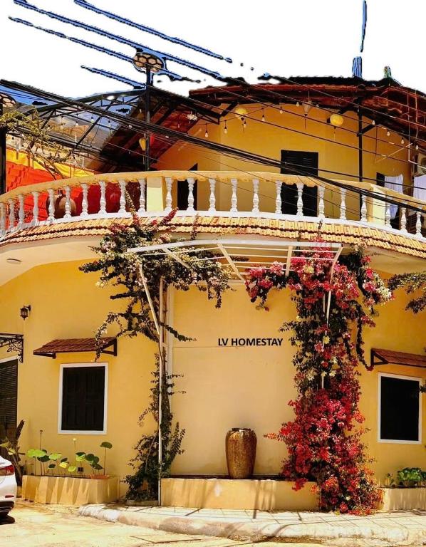 a building with flowers on the side of it at LV Homestay in Nha Trang
