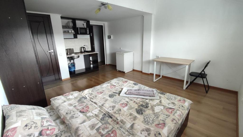 a living room with a bed and a table at Мансарда біля АС2 in Ivano-Frankivsk