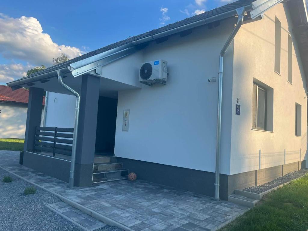 a rendering of a house with a garage at Kuca za odmor PETAR u blizini Parka prirode PAPUK in Lisičine