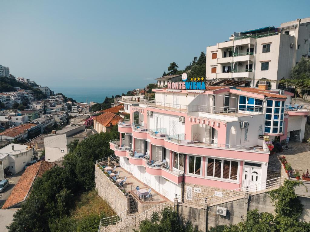 a pink building on the side of a city at Wiena Apartments in Ulcinj