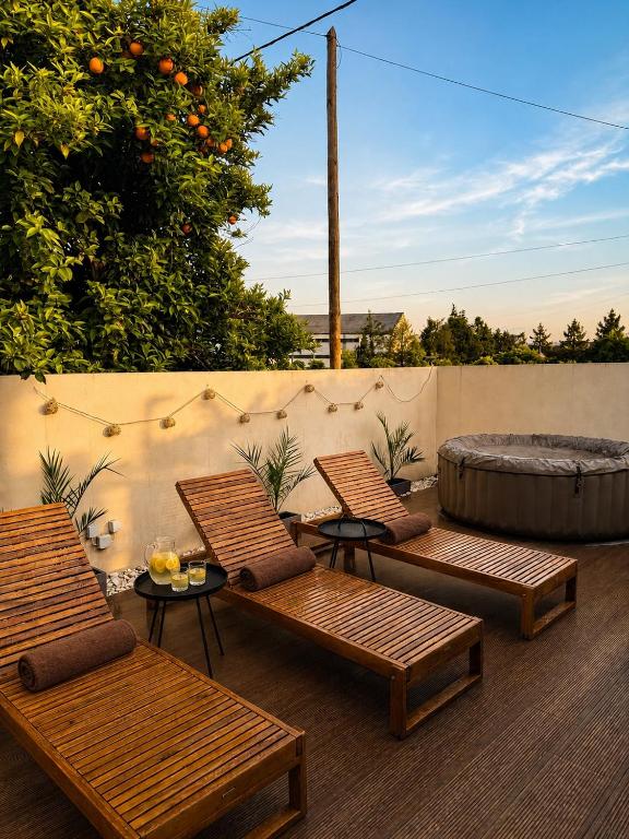 a patio with three lounge chairs and a tub at Casa Carvalho in Peso da Régua