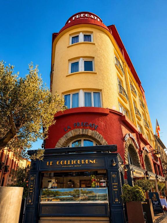 a tall building with a store in front of it at La Frégate in Collioure