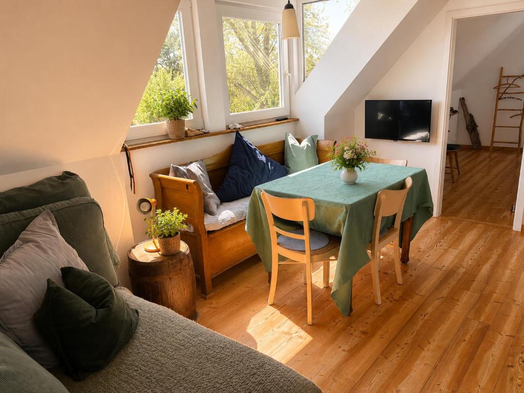 a living room with a table and a couch at Amrum Family Hideaway-Grosse Wohnung in Norddorf für bis zu 6 Personen in Norddorf