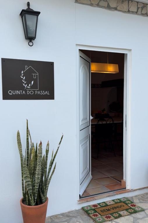 a door to a restaurant with a plant next to it at Quinta do Passal in Coimbra